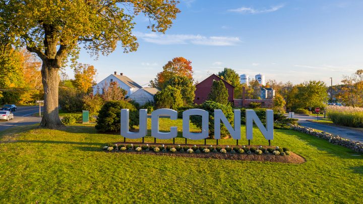 Aerial view of the large UConn sign in the campus entryway