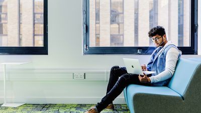 International student at Kaplan International College studying on his laptop