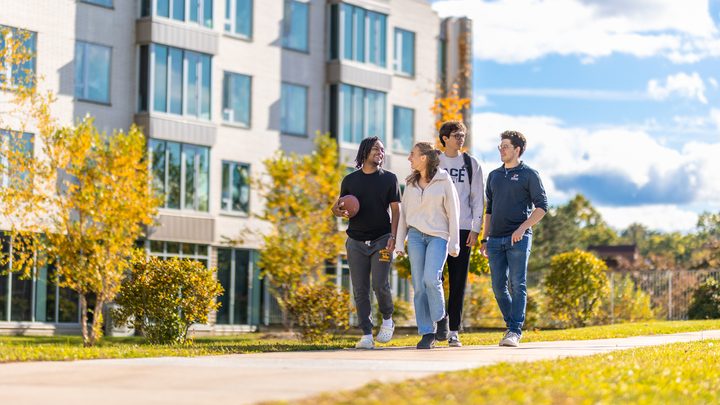 4 Pace university students walking on the Westchester campus