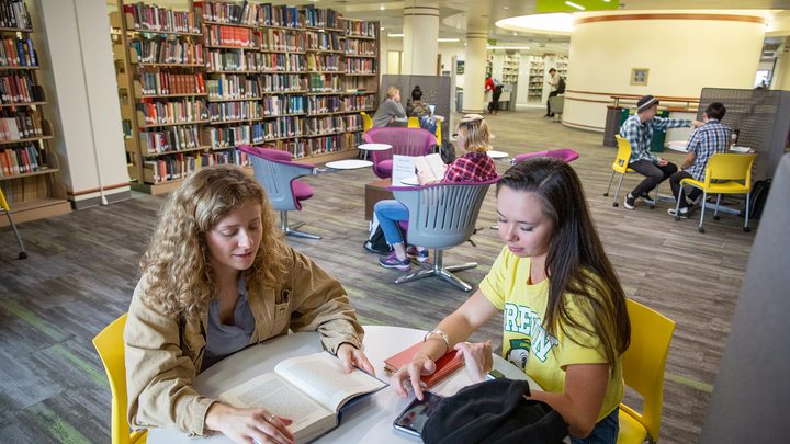 Two UO students studying in group inside the Oregon campus library