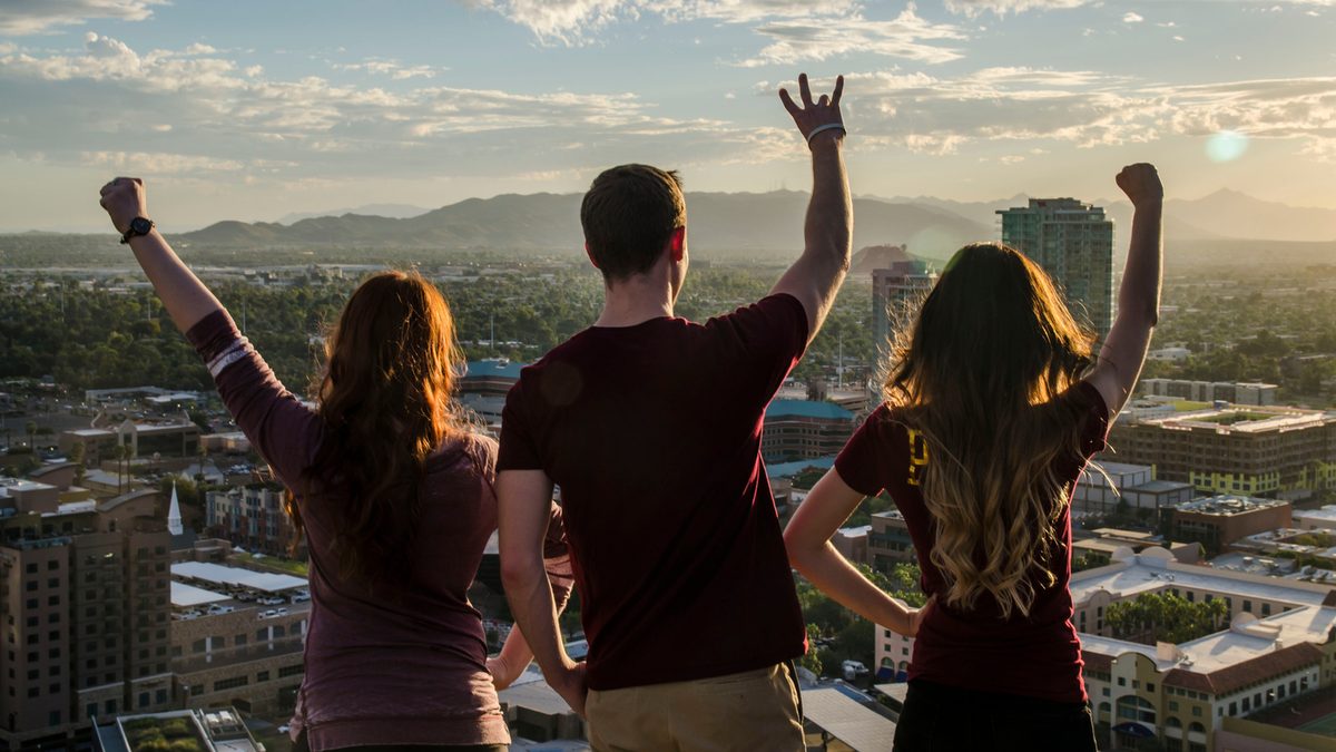 Three ASU students posing towards the Phoenix campus