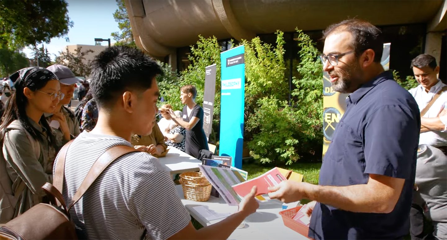 Leaflets for U of A orientation being handed to students