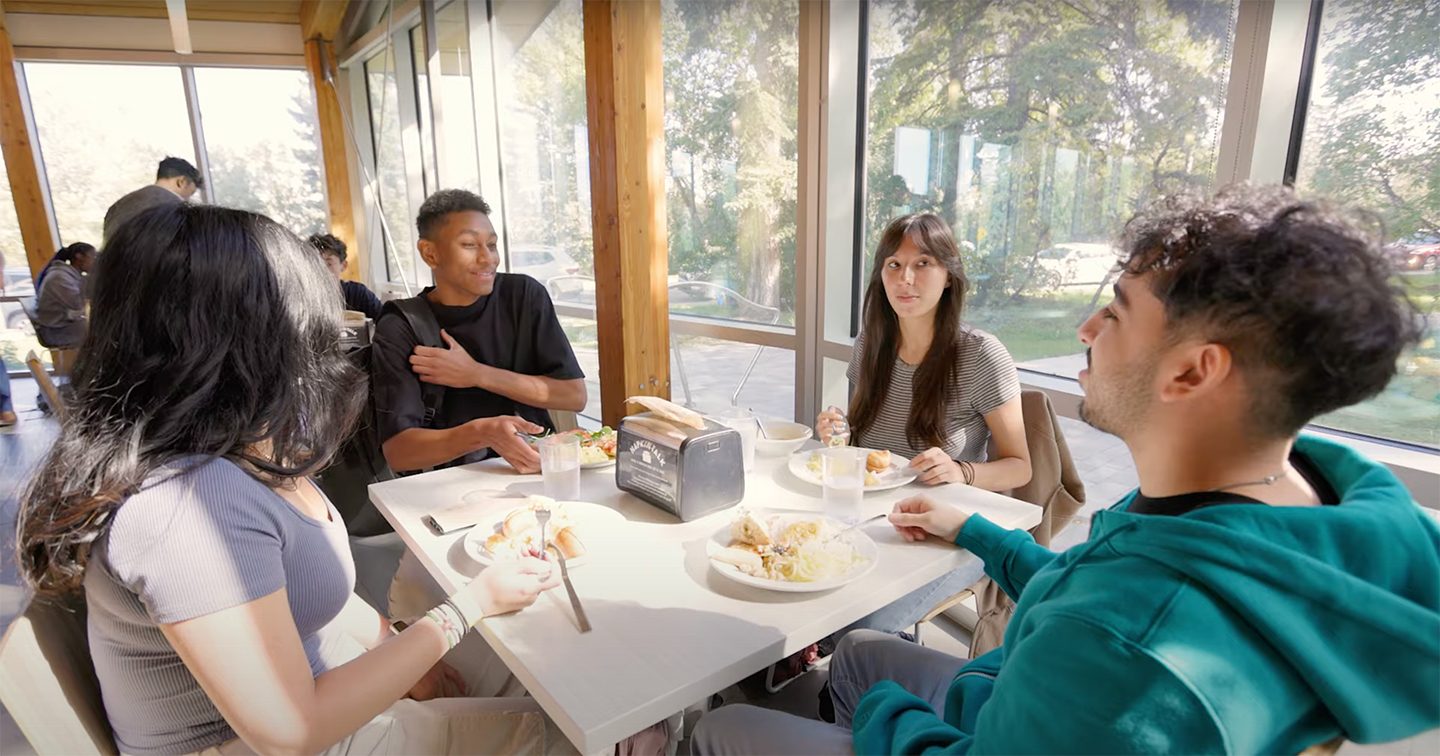 Four students eating lunch at their campus canteen