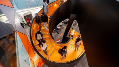 U of A Student Innovation Center that features a bright orange spiral staircase