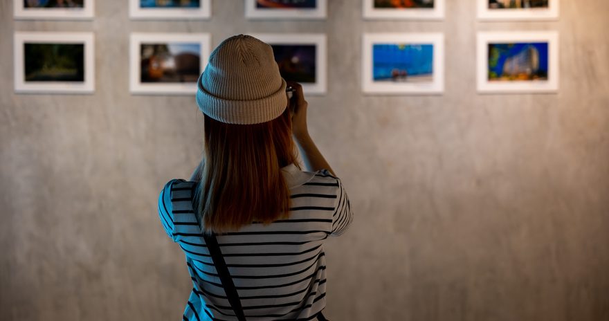 Student holding a camera learning about art in the Art Gallery of Alberta