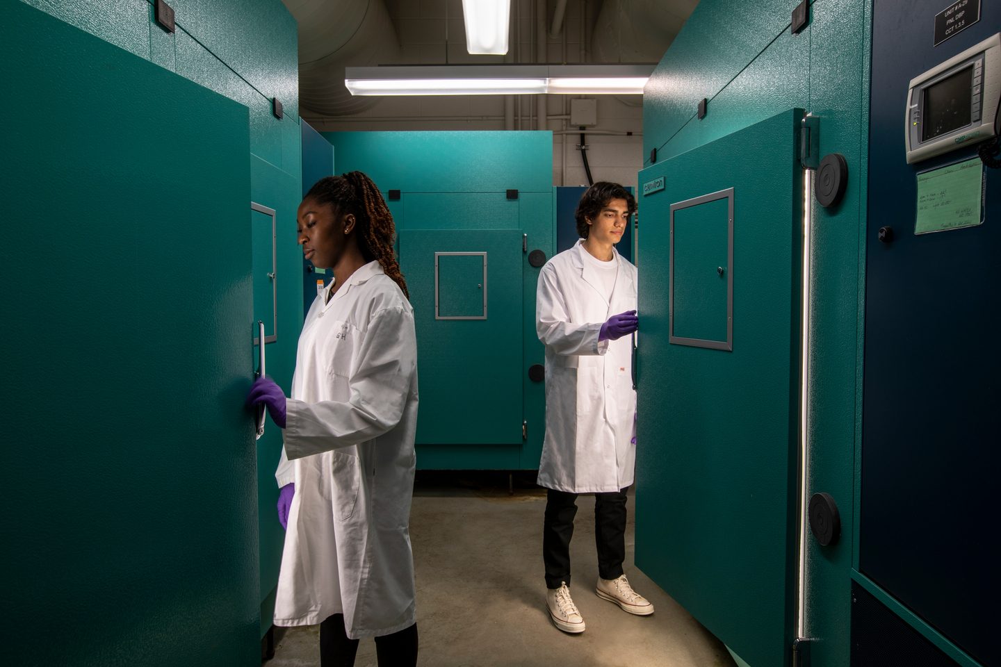 Two students at the Science lab checking on their scientific work