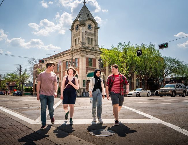 A group of students crossing whyte avenue street