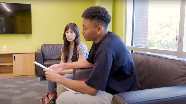 A university of Alberta student sharing notes with a classmate