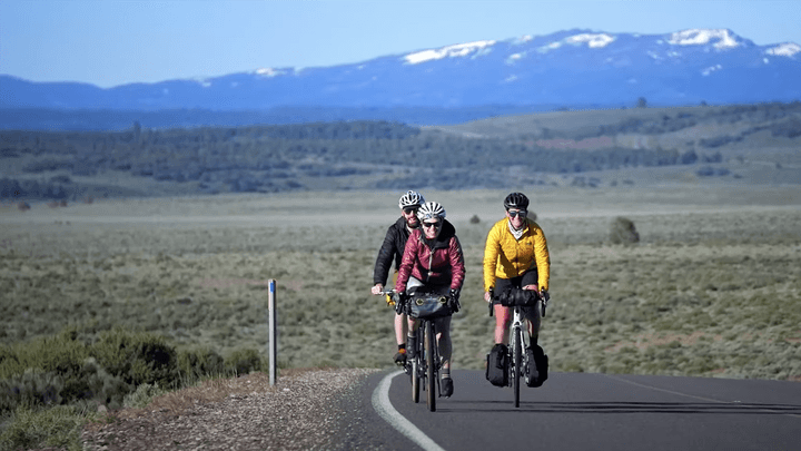 a group of people cycling on the road