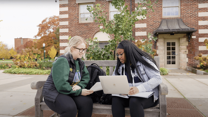 Oregon students having a discussion on the campus bench